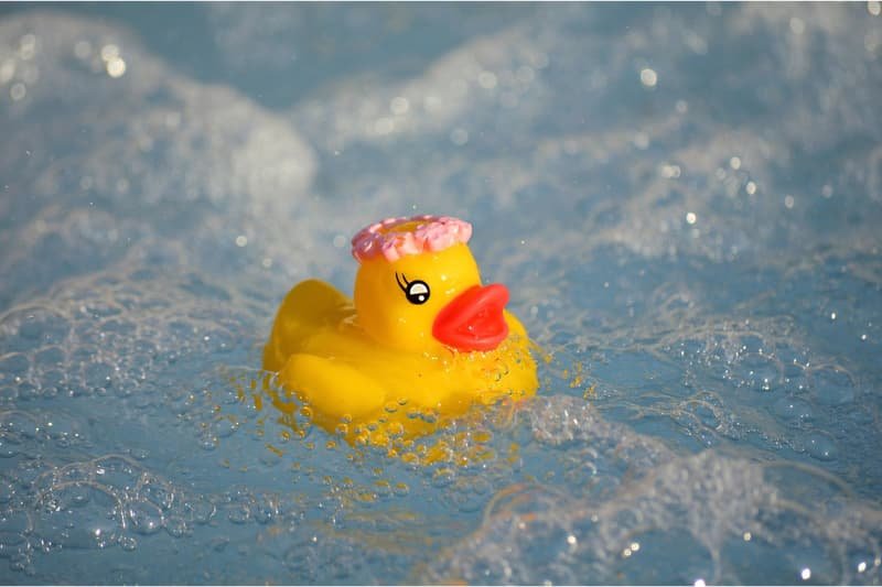 rubber duck in foamy hot tub